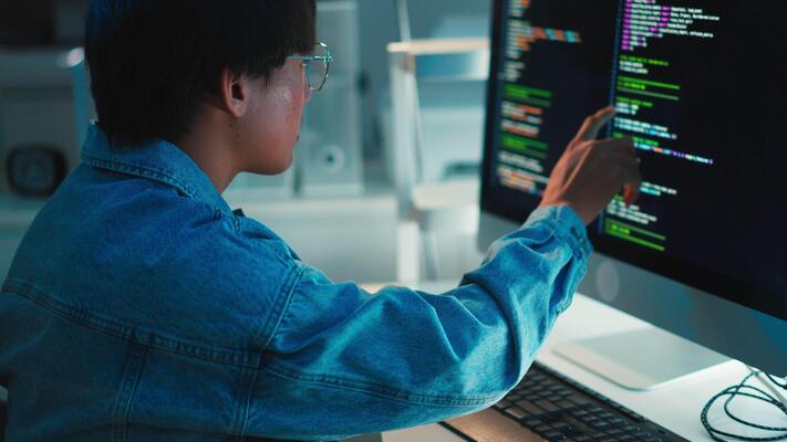 Programmer debugging code on screen - Programmer debugging software code on multi-monitor setup 68587737 ...